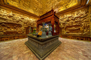 Night view inside of Ky Lan temple, Ninh Binh, Vietnam.  Stone carved base-relief. Human figures...
