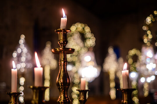Elegant candle arrangement in a dimly lit setting, creating a serene atmosphere for remembrance and reflection during a funeral or memorial service