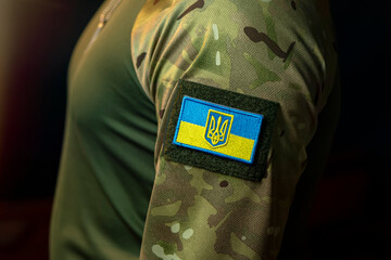 Patch with the Ukrainian flag and coat of arms on the sleeve of a military uniform.