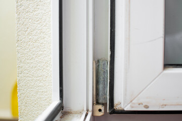 Dust and grime on the rubber seal of an open window close to the street