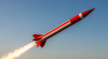 Red and white striped missile launching against a clear blue sky, fiery exhaust trail visible, representing power, speed, and technological advancement