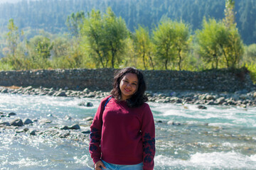 Portrait of a young Indian woman beside Jhelum river at Indian Kashmir. Kashmir tourism, Indian tourist, guided tour concept.