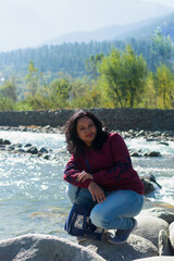 Portrait of a young Indian woman tourist beside Jhelum river at Indian Kashmir. Kashmir tourism, Indian tourist, guided tour concept.