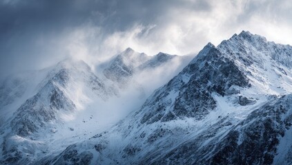 Obraz premium Snowy mountain peaks shrouded in a dramatic winter storm
