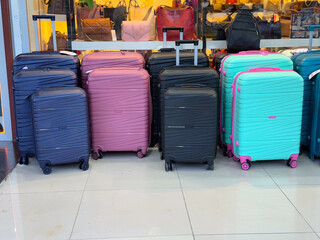 Colorful suitcases standing in store. Travel luggage, transport gear and tourism accessory for...