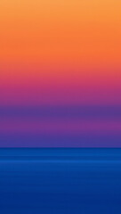 Obraz premium Vibrant sunset sky over ocean reflecting colorful gradients of orange, purple, and blue hues