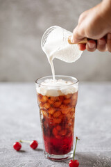 Cherry cola dirty soda in glass. Trending summer drink