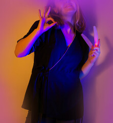 Master of the nail service and  influencer blogger in a professional uniform with nail files in the hands poses at a creative photo shoot in the studio.