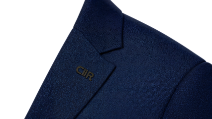 Elegant blue blazer closeup with monogram pin on lapel, modern formal fashion, classic suit jacket texture, business attire detail, stylish tailoring