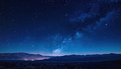 Fototapeta premium Majestic Night Sky - Milky Way Galaxy Over Silhouetted Mountains, Starry Landscape.