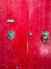 Old red wooden  door in sunlight