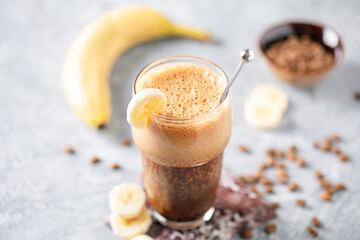 Trending cold drink banana coffee in a glass on the table