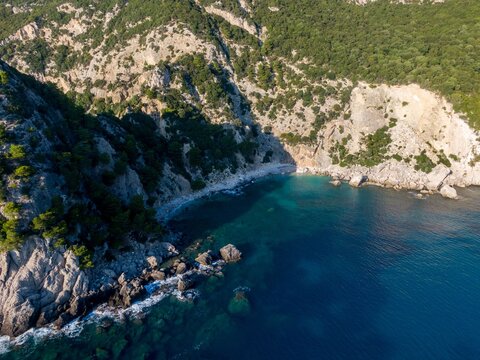 Aerial view of rocky coastline and turquoise waters. - Powered by Adobe