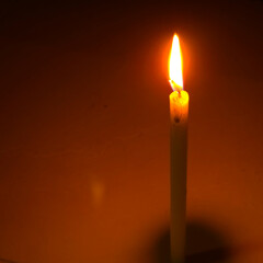 Burning candle light glowing flame