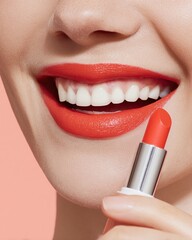 Naklejka premium Close-up of female model & elegant lips with radiant bright and vibrant color lips holding lipstick tube, professional beauty shoot for cosmetic, advertising and luxury makeup brand promotion
