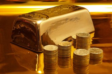  Gold bars with coins on a golden background