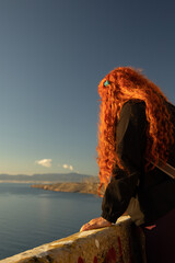 Woman contemplating the Mediterranean Sea during a relaxing sunset, inspiring natural landscape...