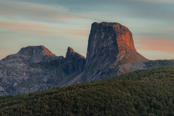 Majestic mountain and canyon landscape under colorful evening clouds, travel destination.