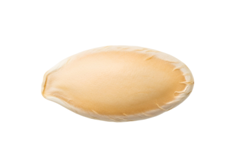 Close-up view of a pale yellow pumpkin seed, smooth and oval-shaped, against a dark background.