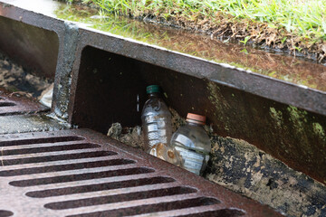 Plastic Bottles Caught in Storm Drain on a residential Street