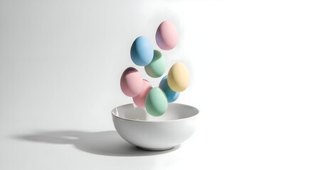 Pastel Easter eggs gently falling into a pristine white bowl evoking springtime