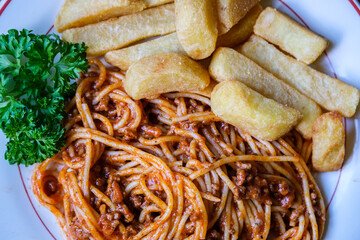 Italian Style Spaghetti Bolognese With Chunky Chips And Parsley Garnish