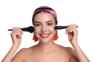 Beautiful woman with makeup brushes on white background