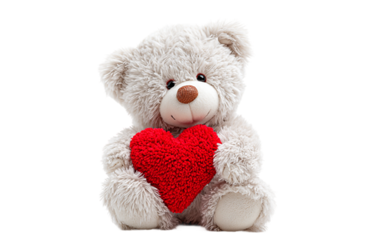 Cute white teddy bear holding a red heart isolated on transparent background