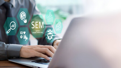 SEM, Search Engine Marketing Concept. A Business person using laptop with SEM icons on visual...