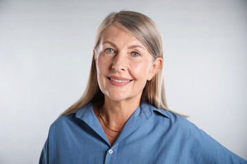 Portrait of beautiful senior woman on white background