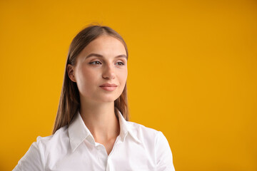 Portrait of beautiful woman on yellow background. Space for text