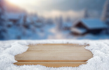 Empty copy space on fresh snow with background of frozen winter mountains and clear blue sky on sunny day. Concept of winter holidays, seasonal product placement, cold weather and mountain nature.