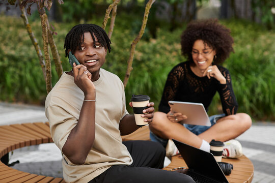 Young couple enjoying remote work in the city while embracing summer vibes