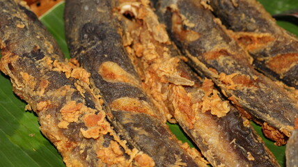 Crispy fried catfish served on banana leaves, traditional Indonesian cuisine and authentic Asian food