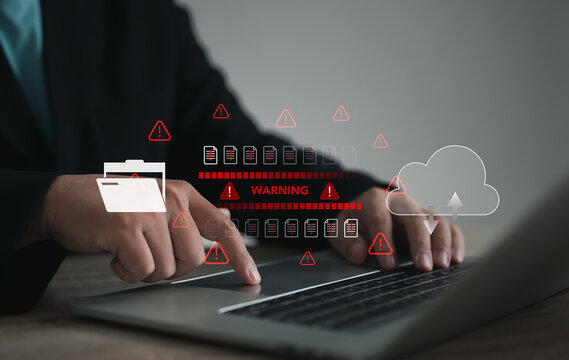 Cybersecurity concept showing businessman using laptop with warning alert icons, cloud data storage risks, and digital threats. Technology background for data protection, hacking, and IT security.