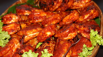 Traditional Indonesian spicy grilled shrimp with chili sauce served on banana leaf in rustic food style