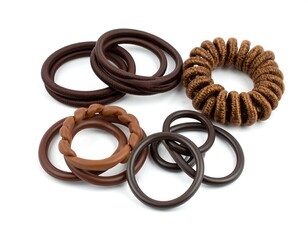 Fototapeta premium Assorted brown hair ties on white background (1)