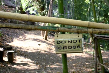 Bamboo barrier with warning sign: 