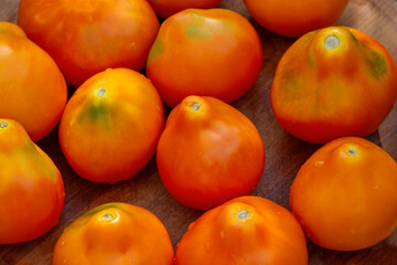 Healthy organic tomato yellow truffle on a wooden background. Tomatoes yellow truffle on wooden background.