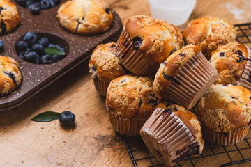 Blueberry muffins on a rustic table in a mold
