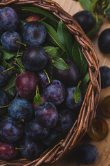 Ripe blue plums in a basket
