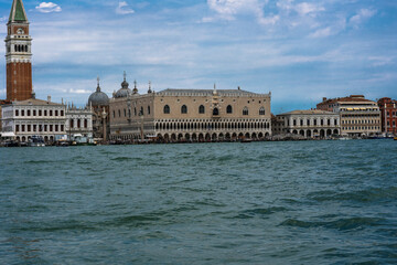 Venetian Landmark: A scenic view of buildings along the water in Venice, Italy on a partly cloudy day. Architectural beauty.