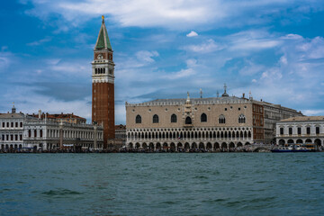 Stunning view of historical waterfront buildings featuring intricate arches and a tall tower with a...