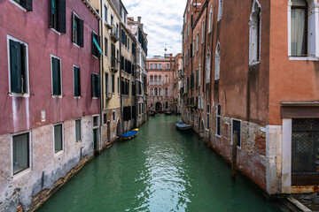 Venetian Canal Scene: Quaint waterways lined with colorful buildings and boats create a picturesque view of the city's charm.