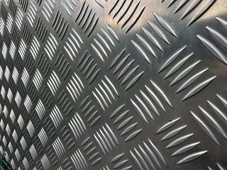 A beautifully textured metal sheet featuring a striking diamond pattern