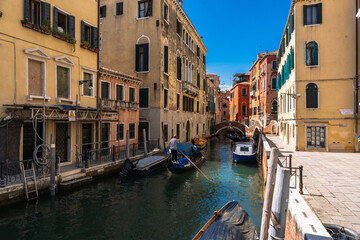 Picturesque Venice canal lined with colorful buildings and boats creating a classic scene of Italian waterway charm.