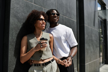Young couple enjoying a stylish summer date in the heart of the urban cityscape