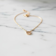 Close-up of gold necklace on white marble surface, elegant jewelry