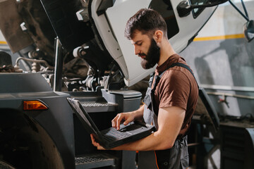 Skilled mechanic diagnosing truck engine issues
