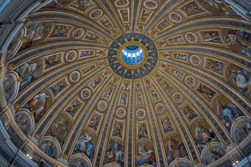 Ornate dome ceiling with religious artwork, featuring a central oculus allowing natural light into the grand interior space.